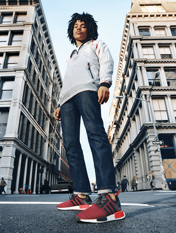 Model Luka Sabbat appears in campaign imagery for Adidas Originals, wearing its NMD Runner sneakers in a red, black and white colorway.