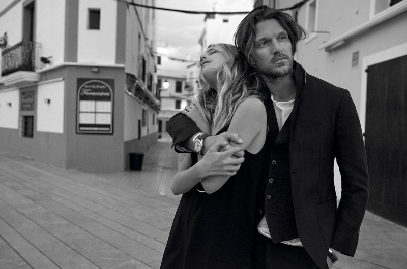 Shaun DeWet embraces Dree Hemingway, wearing a sports jacket and waistcoat with a casual t-shirt.