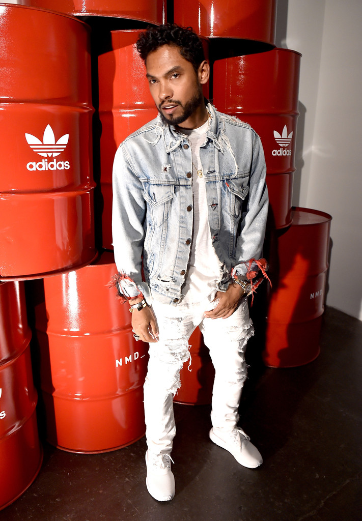 Wearing Adidas Originals NMD Runner sneakers in white, Miguel doubles down on denim.