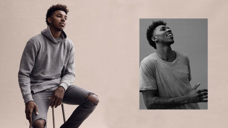 Nick Young sports a John Elliott hoodie with distressed denim jeans.