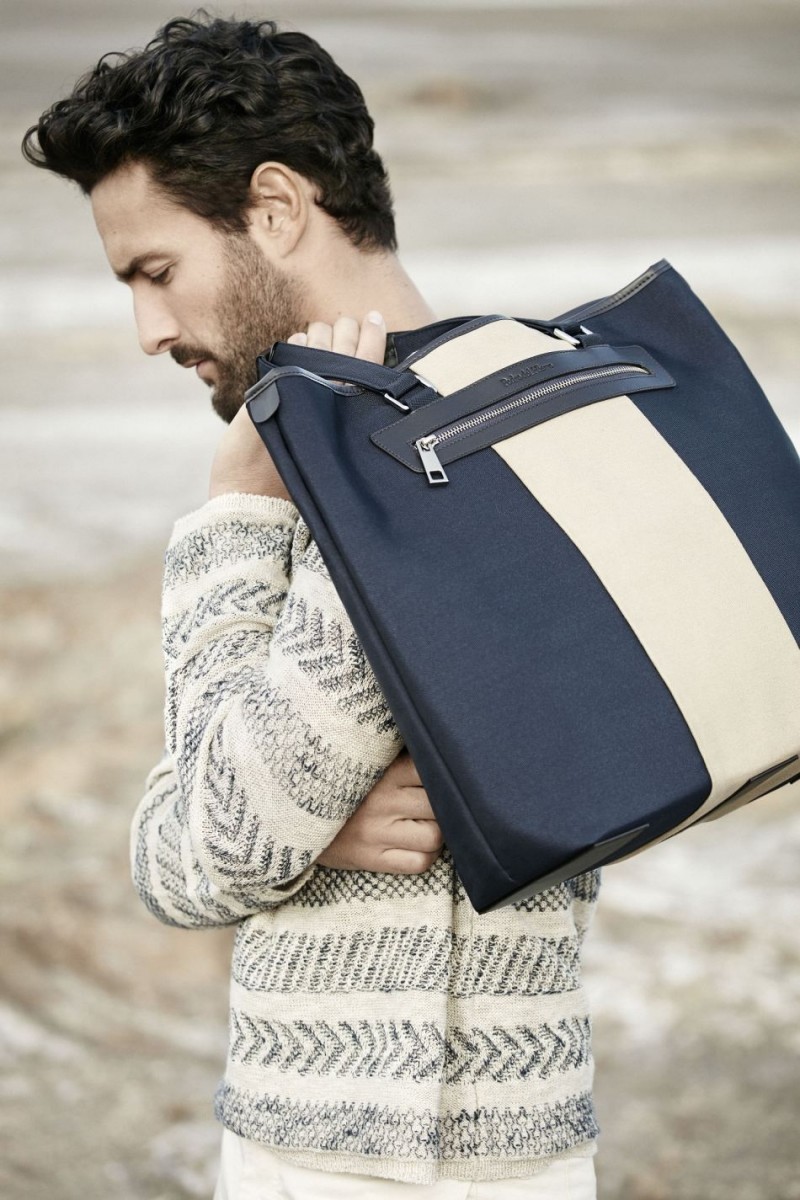 Dressed in a striped jumper, Noah Mills poses with an oversized bag for Pedro del Hierro's spring-summer 2016 campaign.