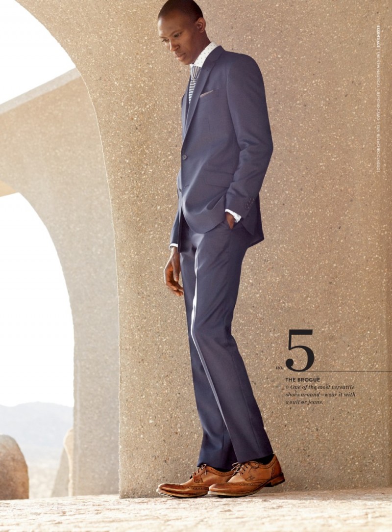 Armando Cabral dons a grey Ted Baker London suit with brown leather wingtip shoes.