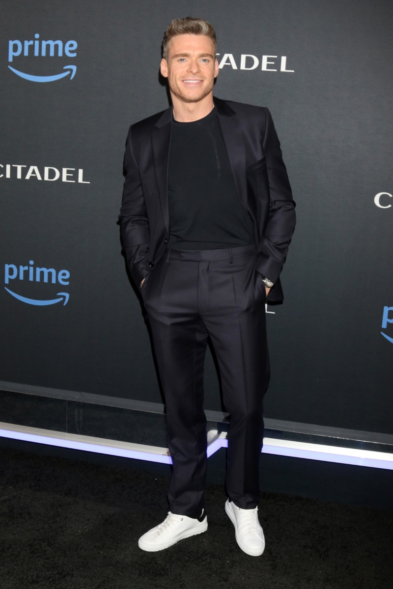 Richard Madden attends the April 2023 premiere of the Citadel series in Los Angeles, California. The actor wears a navy Dior Men suit with white sneakers.