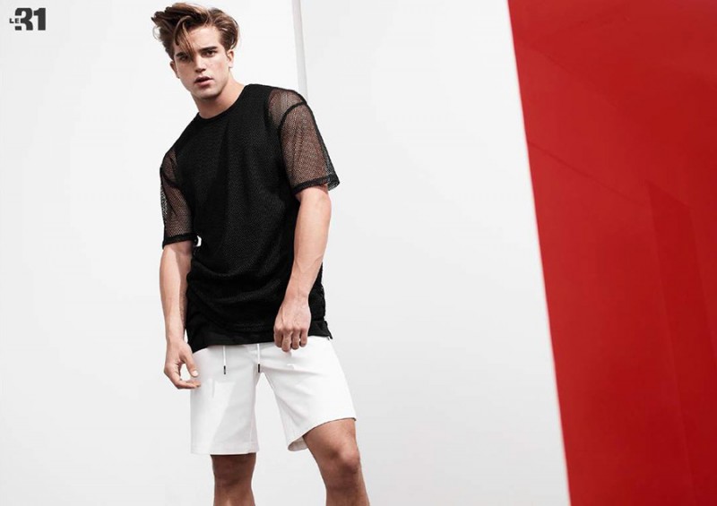 River Viiperi models a mesh tee with white shorts.