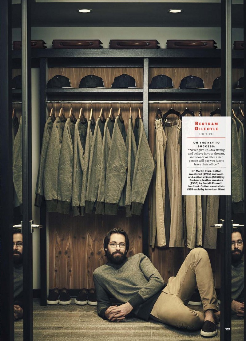Martin Starr relaxes in a wardrobe, sporting an outfit from Burberry with Fratelli Rossetti sneakers.
