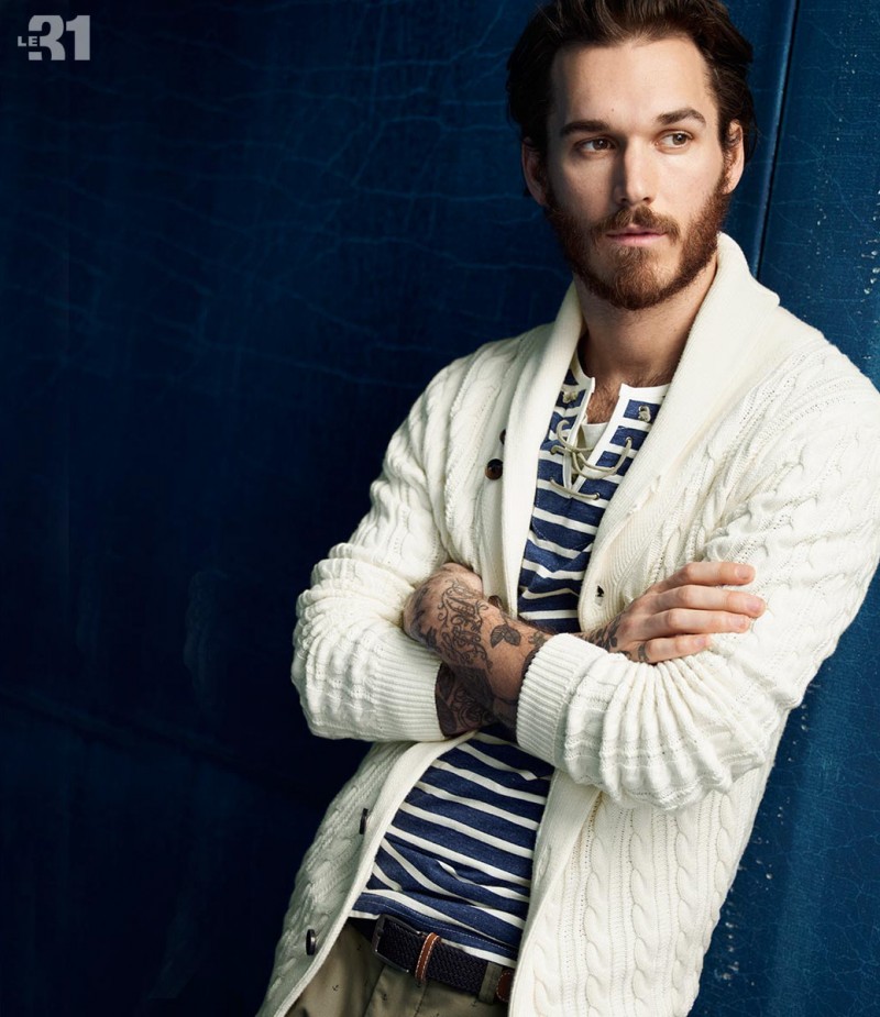 Pictured in a shawl neck cardigan sweater and a striped henley, model David Alexander Flinn embraces nautical styles from Simons' LE 31 range.