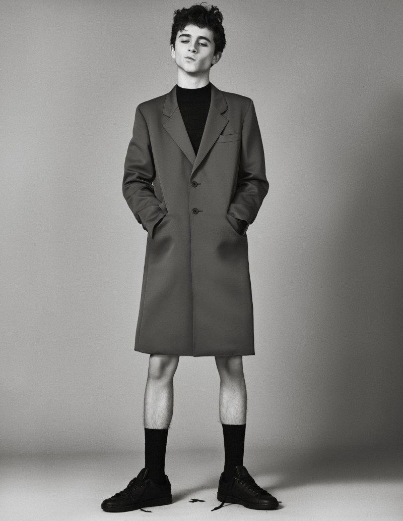 Timothée Chalamet wears jacket Prada, sweater Lemaire, socks Falke and sneakers Adidas Originals.