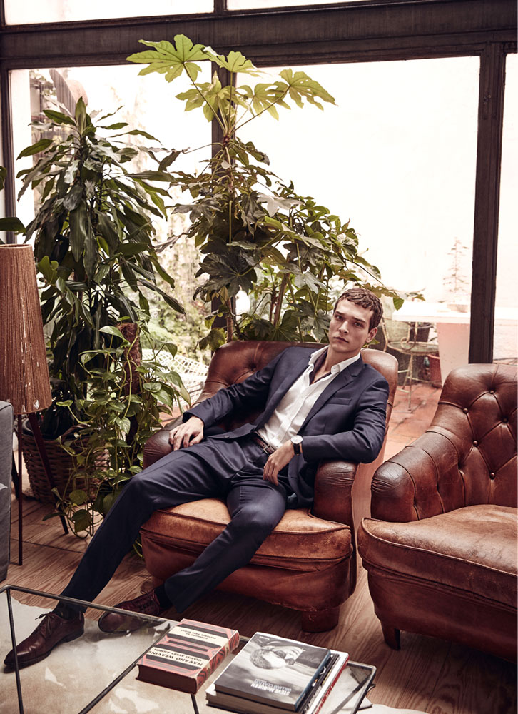 Alexandre Cunha lounges in a navy suit from Hackett.