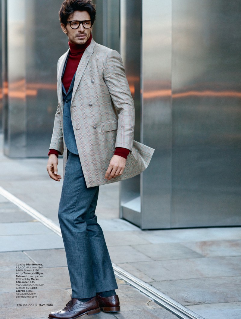 Donning a check coat from Dior Homme with a suit by Tommy Hilfiger Tailored, Andres Velencoso Segura plays its smart in a black framed pair of glasses.