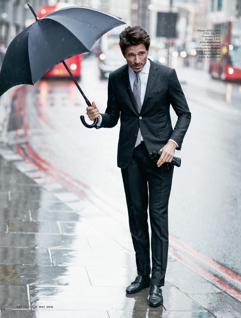Andres Velencoso Segura is caught out in the rain, wearing a suit from Corneliani.