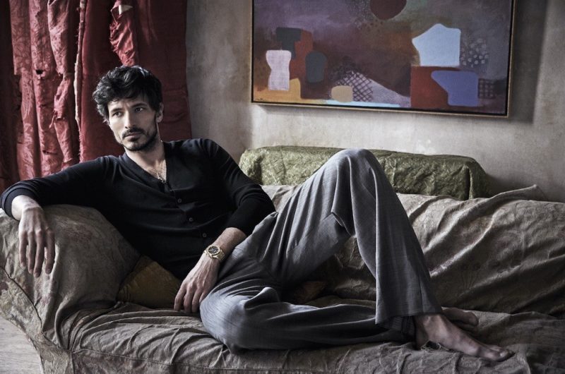 Andres Velencoso Segura lounges in a chic cardigan and check trousers.