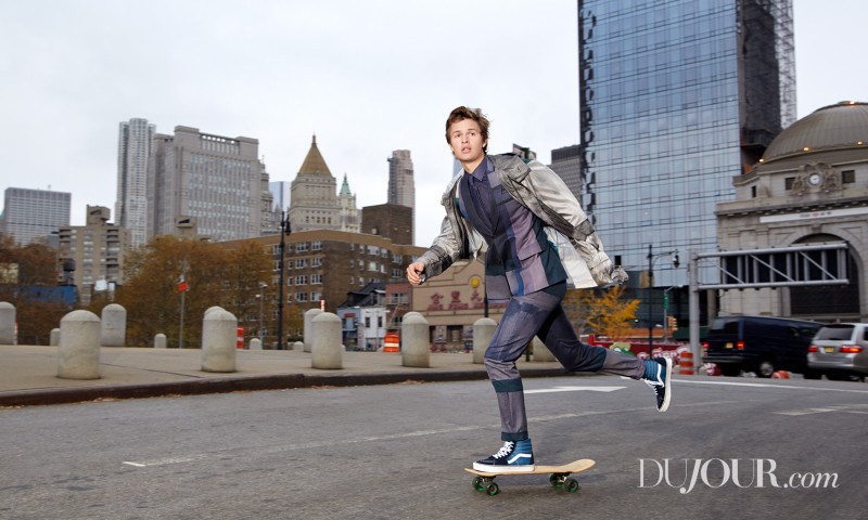 Ansel Elgort wears parka, shirt and tie Brioni and sneakers Vans.