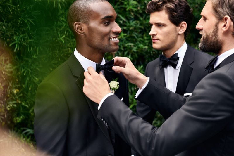 RJ Rogenski plays best man, straightening out Corey Baptiste's bow-tie.