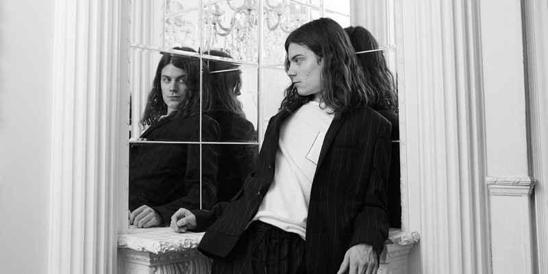 BØRNS wears t-shirt Rag & Bone, loafers Versace, pinstripe jacket and joggers JUUN.J.