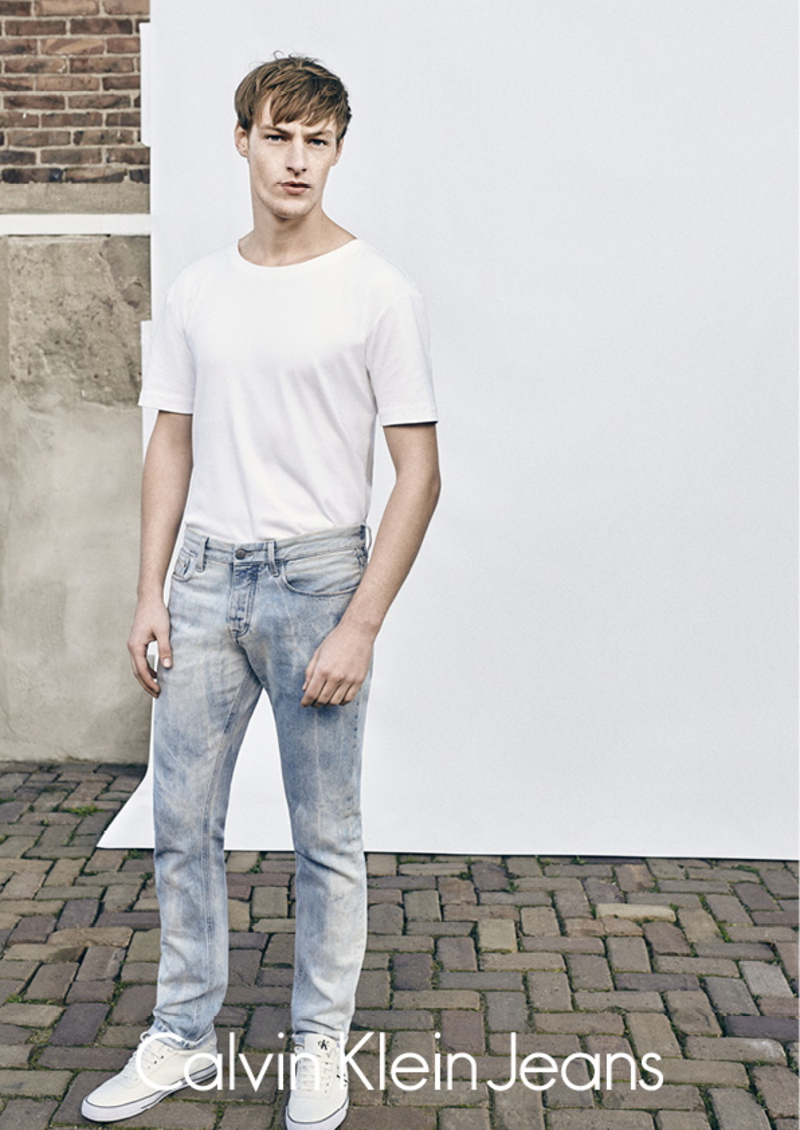 Roberto Sipos models a classic white tee and denim jeans for Calvin Klein Jeans.