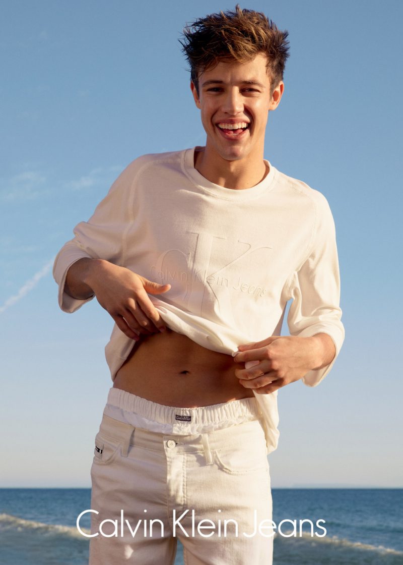 Cameron Dallas embraces a monochromatic white ensemble for Calvin Klein Jeans' summer 2016 campaign.