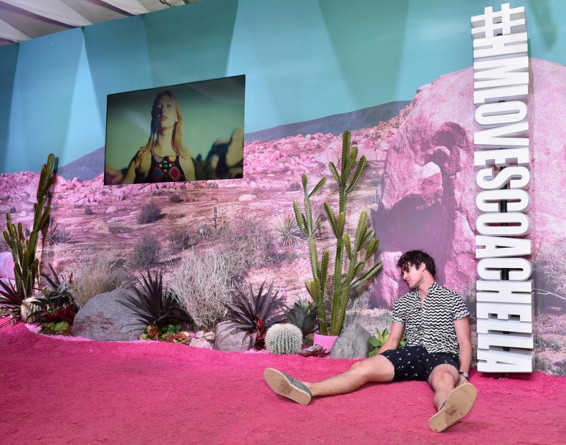 Darren Criss poses for a cheeky picture at the H&M Love Coachella Pop Up.