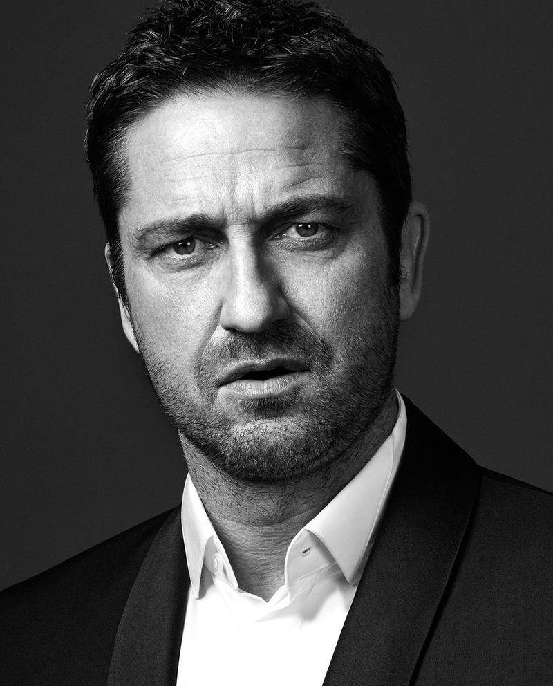 Gerard Butler sits for a portrait, dressed in BOSS Hugo Boss.