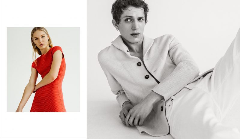Xavier Buestel models a Giorgio Armani shawl-collar sweater jacket and white denim jeans.