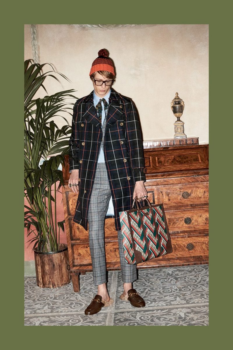 Gucci makes a sartorial statement with a bold windowpane print double-breasted coat.