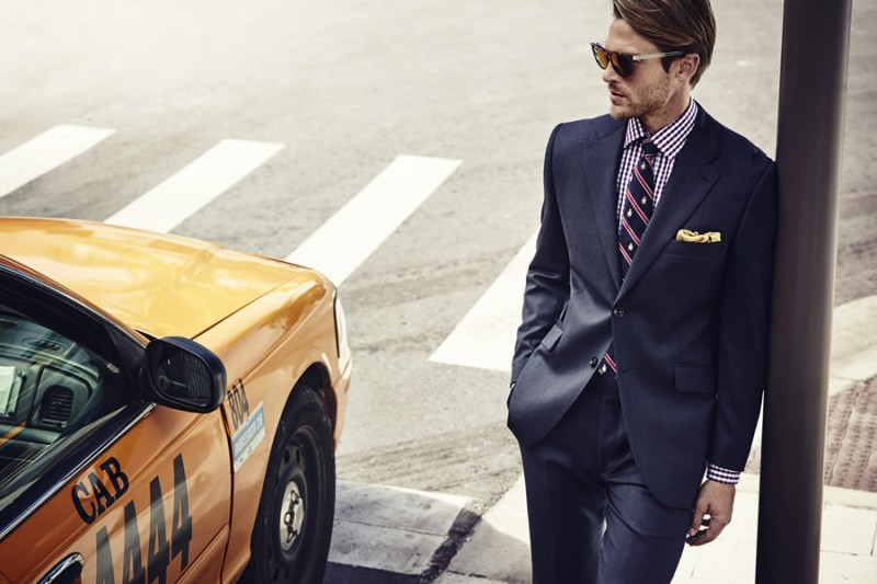 Stepping out for Howick Tailored, Jason Morgan embraces a professional cool in navy suiting and a pair of stylish frames.