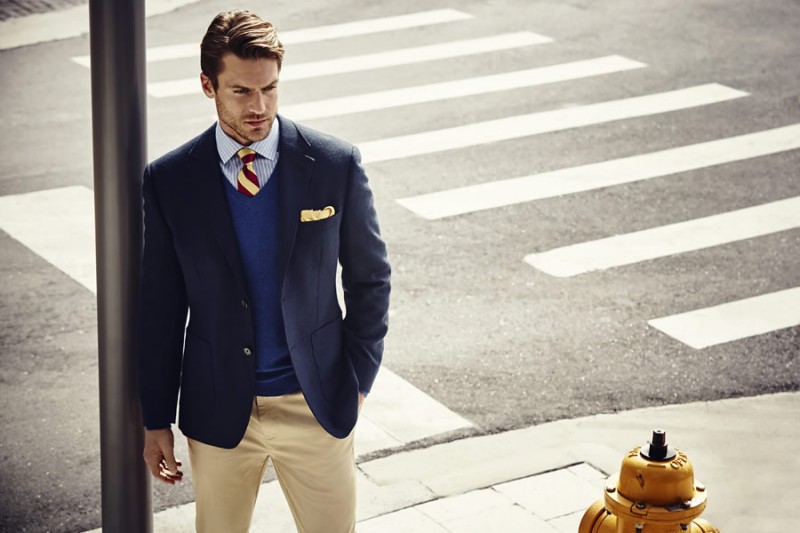 Jason Morgan dons a v-neck sweater with a striped oxford shirt and navy sports coat for Howick Tailored from House of Fraser.