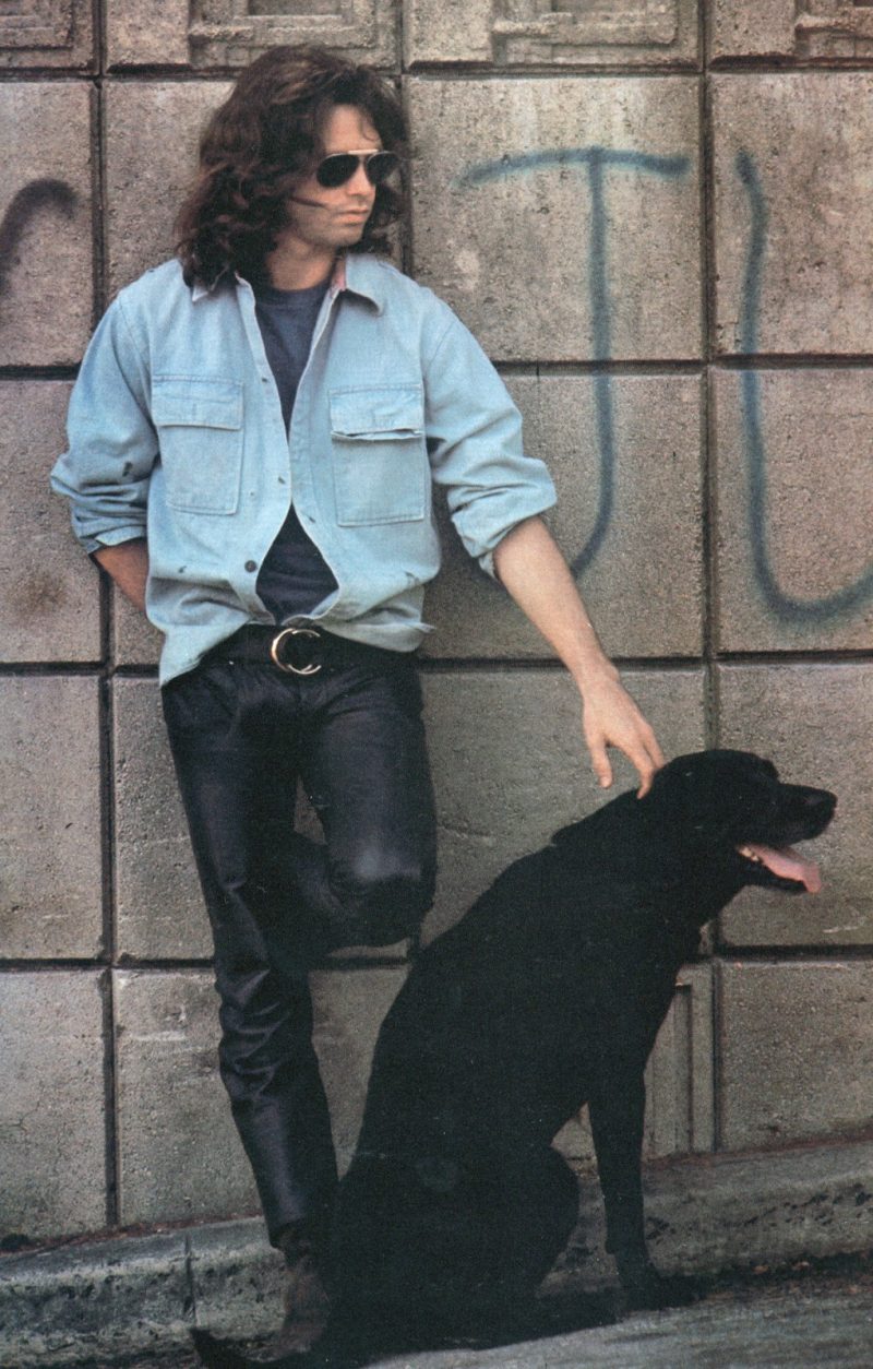 Jim Morrison takes it easy in leather pants and an oversized shirt jacket.