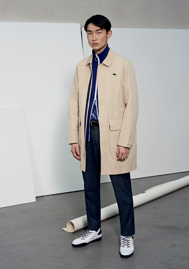 Sang Woo Kim's sports Lacoste Live's take on the iconic Mac jacket, worn over a trendy tracksuit jacket.