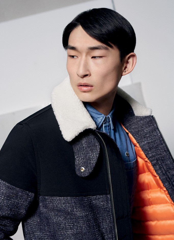 Sang Woo Kim wears a shearling collared multi-textile jacket from Lacoste Live's fall-winter 2016 collection.