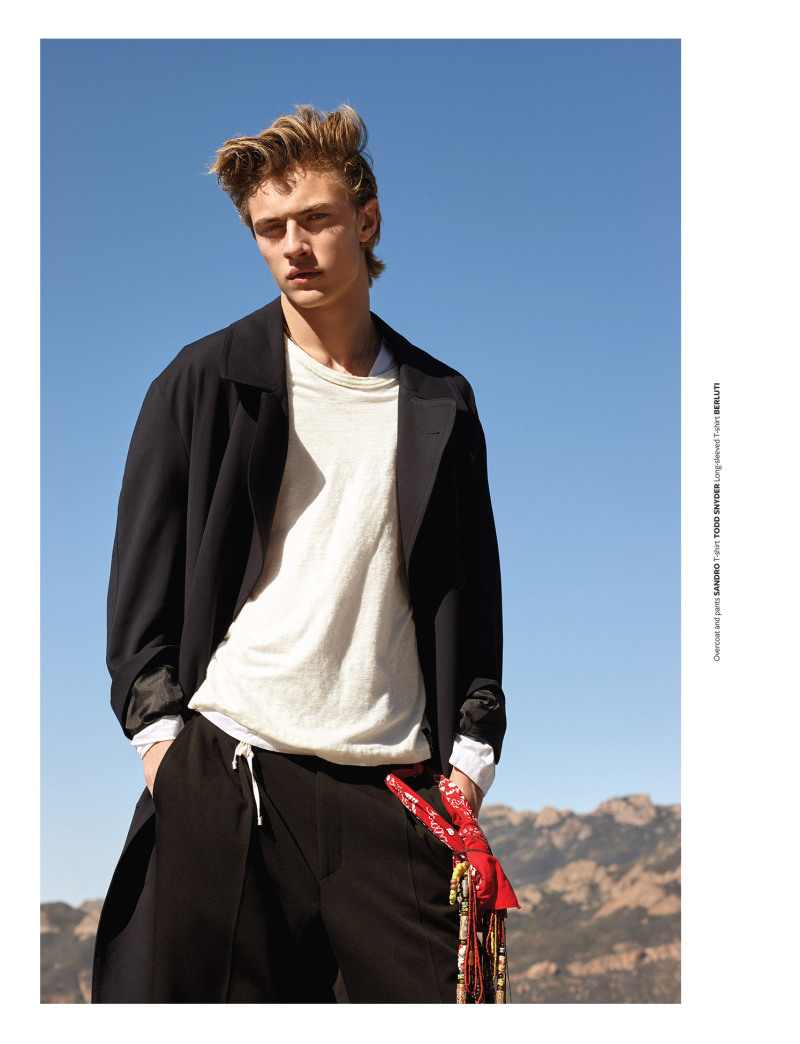 Lucky Blue Smith embraces oversized styles, wearing a coat and pants from Sandro with a Todd Snyder t-shirt and Berluti long-sleeve top.