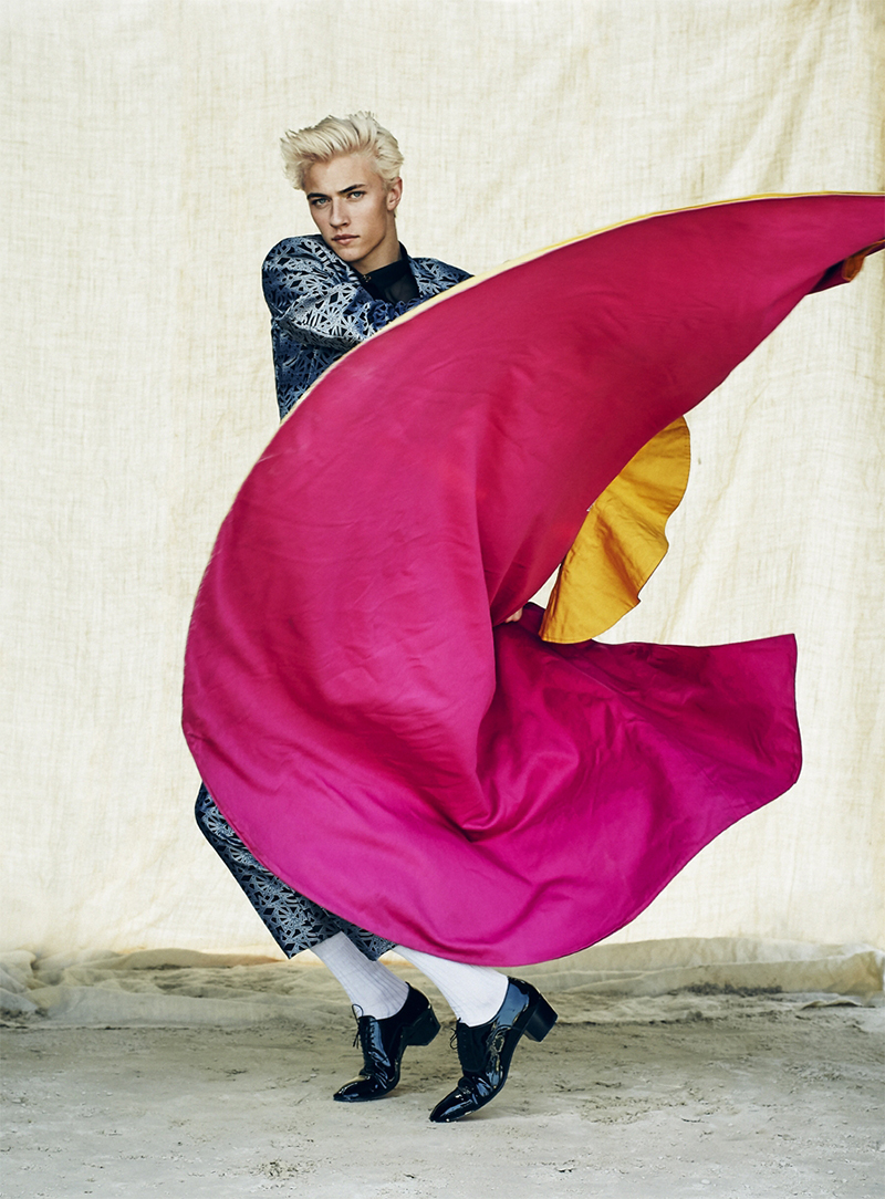 Lucky Blue Smith takes on the actions of a torero, wearing all clothes Les Hommes and shoes Christian Louboutin.