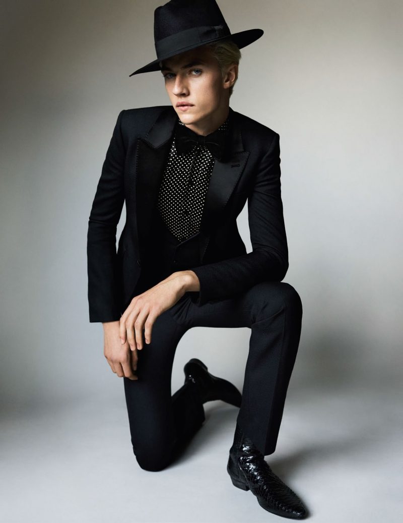 Donning quite the hat, Lucky Blue Smith is a svelte vision in Saint Laurent by Hedi Slimane.