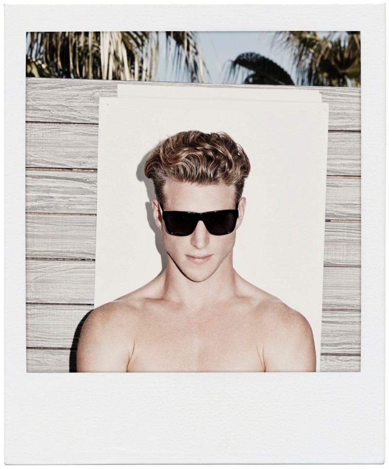 Model Roger Frampton wears Orlebar Brown's Withycombe black/dark grey sunglasses.