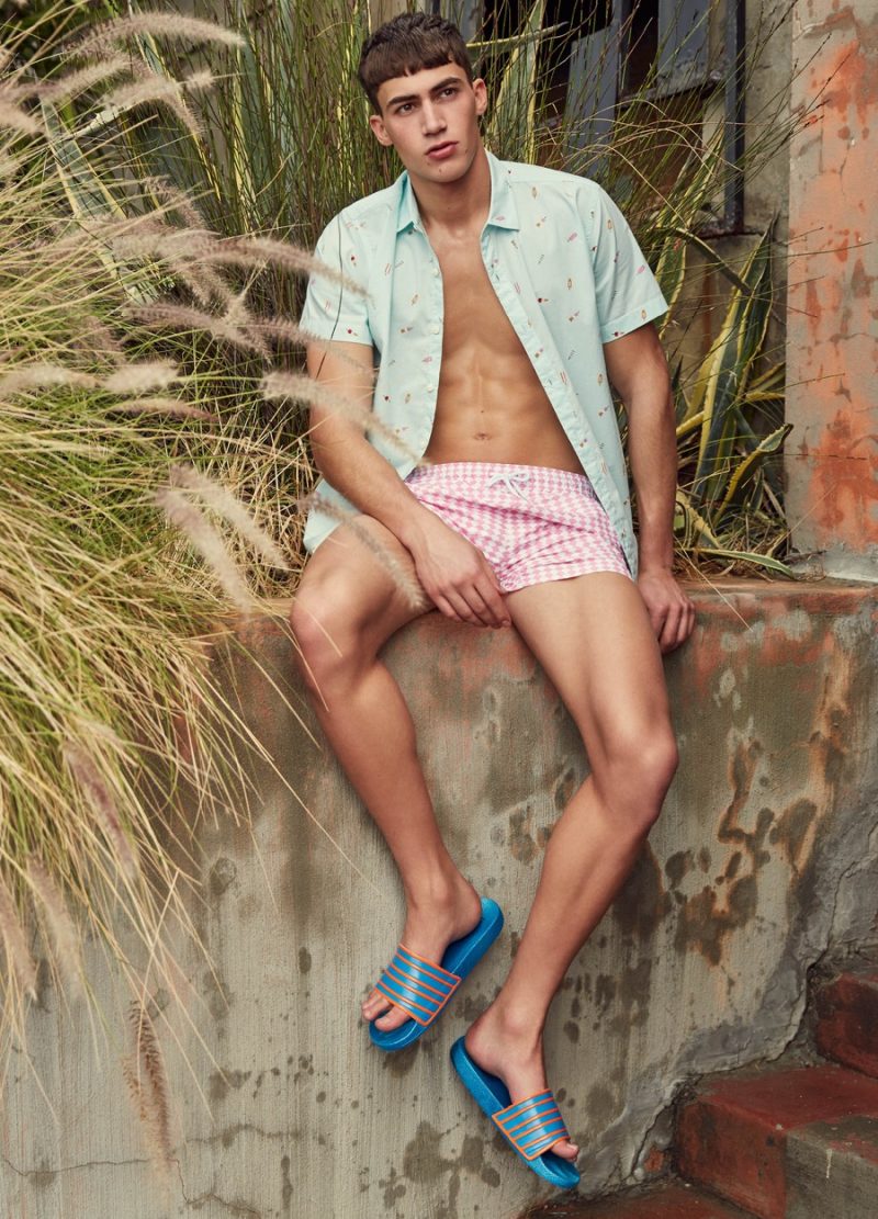 Alessio Pozzi embraces pastels in a checker print swimsuit and short-sleeve shirt for Primark's summer 2016 campaign.