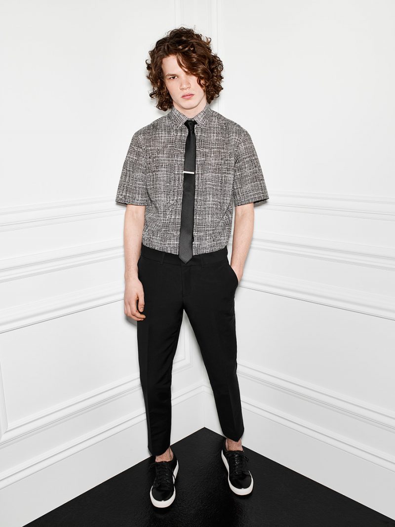 Short-Sleeve Wonder: Arran Turton-Phillips keeps it simple in black trousers, sneakers and a Le 31 engraved blackboard short-sleeve shirt.