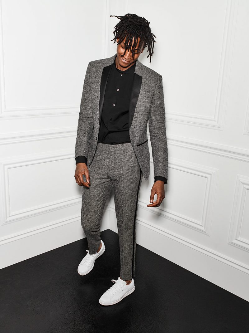 Texture Grab: Matthew Davidson models Le 31's 2.0 tuxedo jacket with a black band collar shirt and white sneakers.