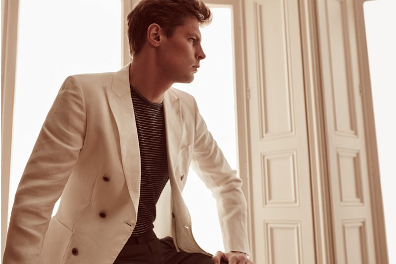 Adrian Wlodarski wears Pope B white double-breasted jacket, Tropics striped pocket tee and Griffin trousers from Reiss.