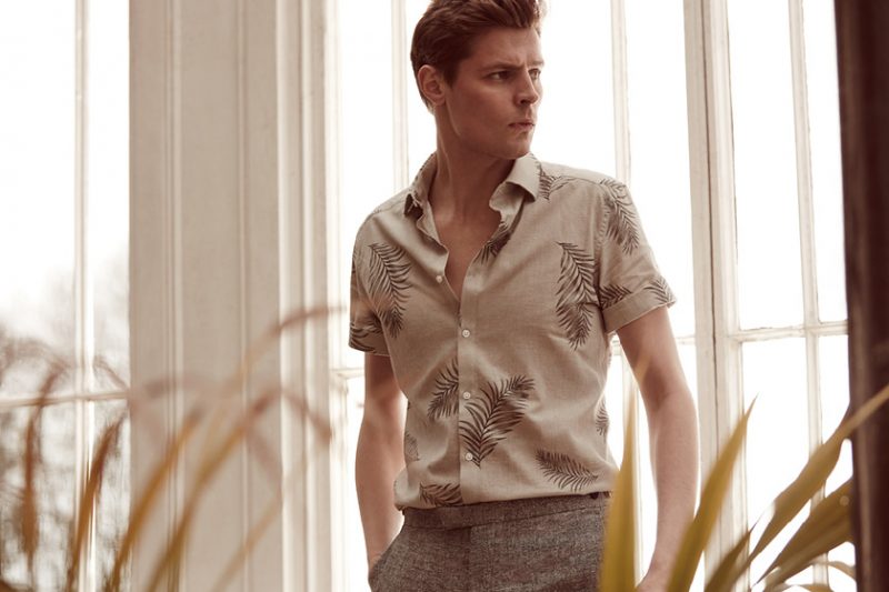 Adrian Wlodarski wears Feather patterned short-sleeve shirt and Luxor T trousers from Reiss.