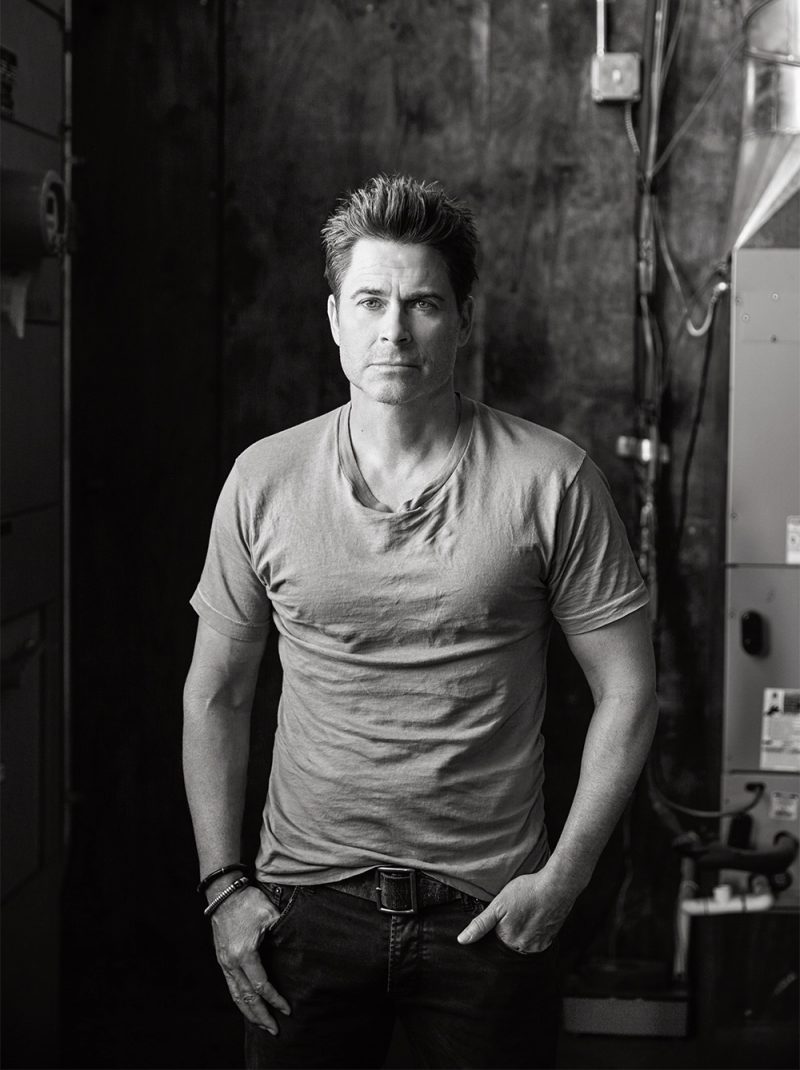 Rob Lowe embraces a relaxed aesthetic in a Kelly Cole t-shirt and Prada denim jeans.