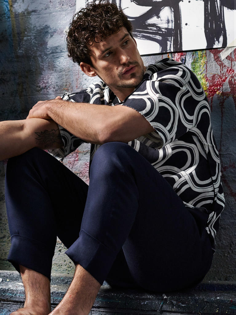 Sam Webb sports a graphic black and white shirt from Dolce & Gabbana with Neil Barrett trousers.