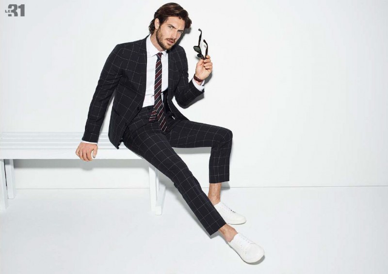 Justice Joslin is a smart image in a navy windowpane suit from Simons LE 31.
