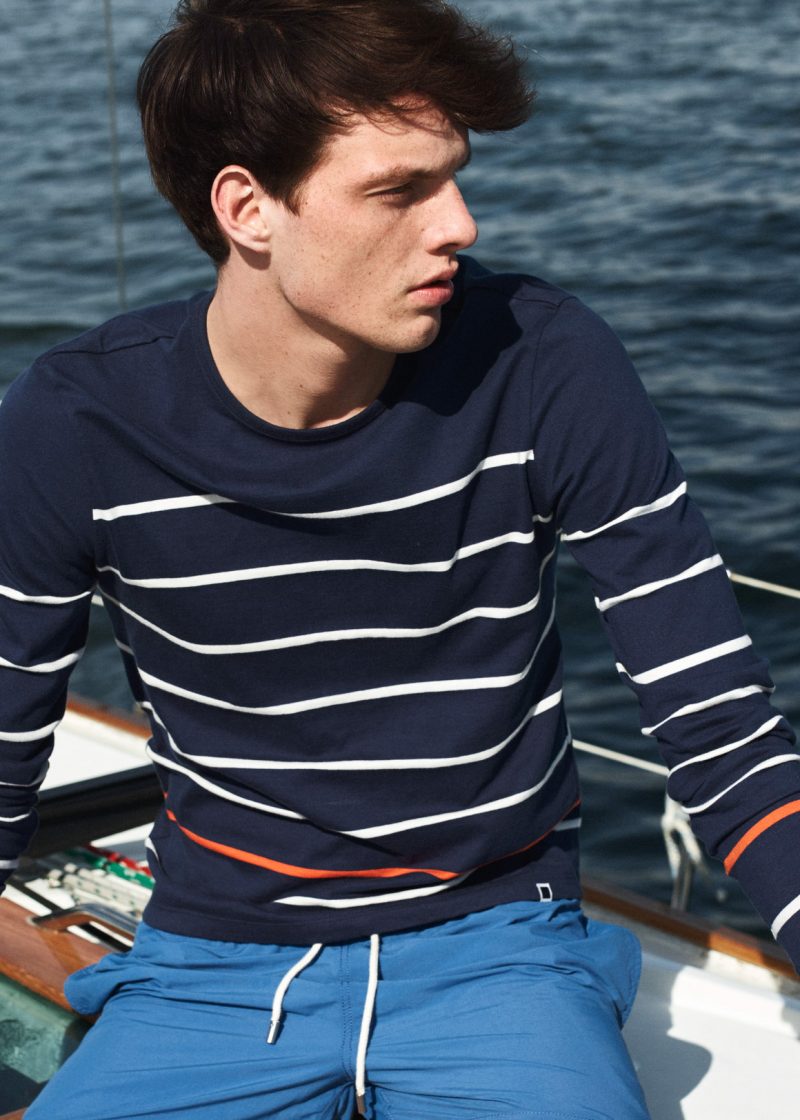 Rocky Harwood embraces a nautical flair in a navy breton stripe tee from Solid & Striped.