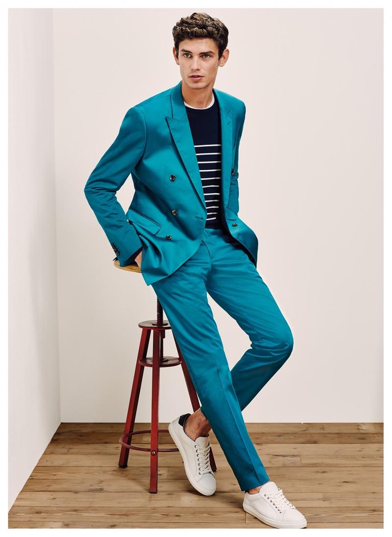 Arthur Gosse wears a Tommy Hilfiger Tailored double-breasted turquoise suit with a lightweight breton stripe sweater.