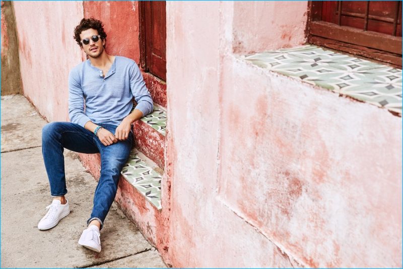 Paul Kelly relaxes in a long-sleeve henley and denim jeans from Bonobos. 