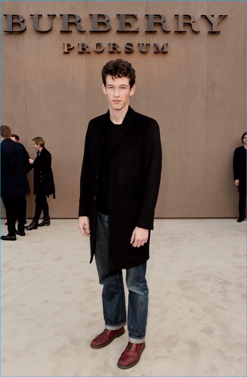 Callum Turner poses for pictures at Burberry Prorsum's fall-winter 2014 menswear show.