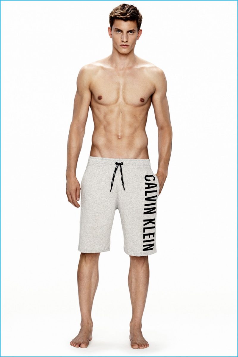 Benjamin Benedek models grey Calvin Klein logo sweatshorts. 