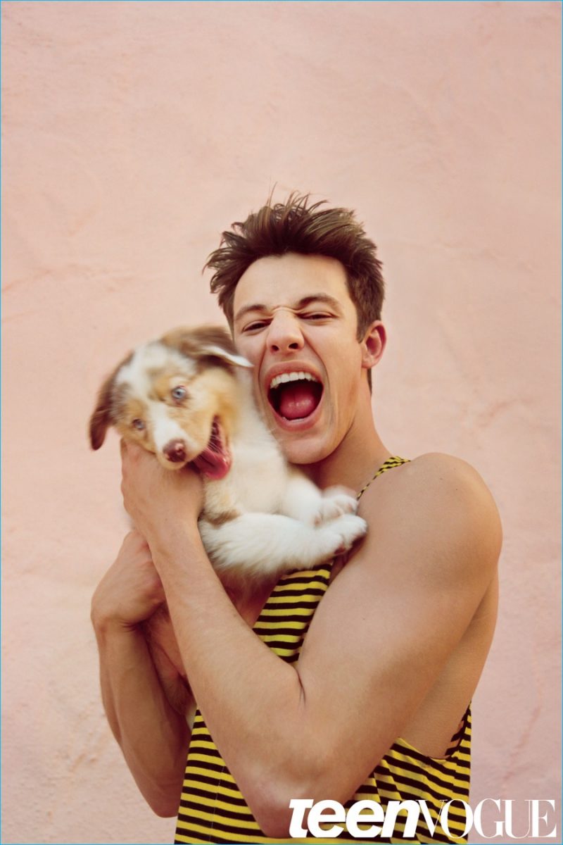 Cameron Dallas cozies up to a puppy as he rocks a striped tank from Prada.