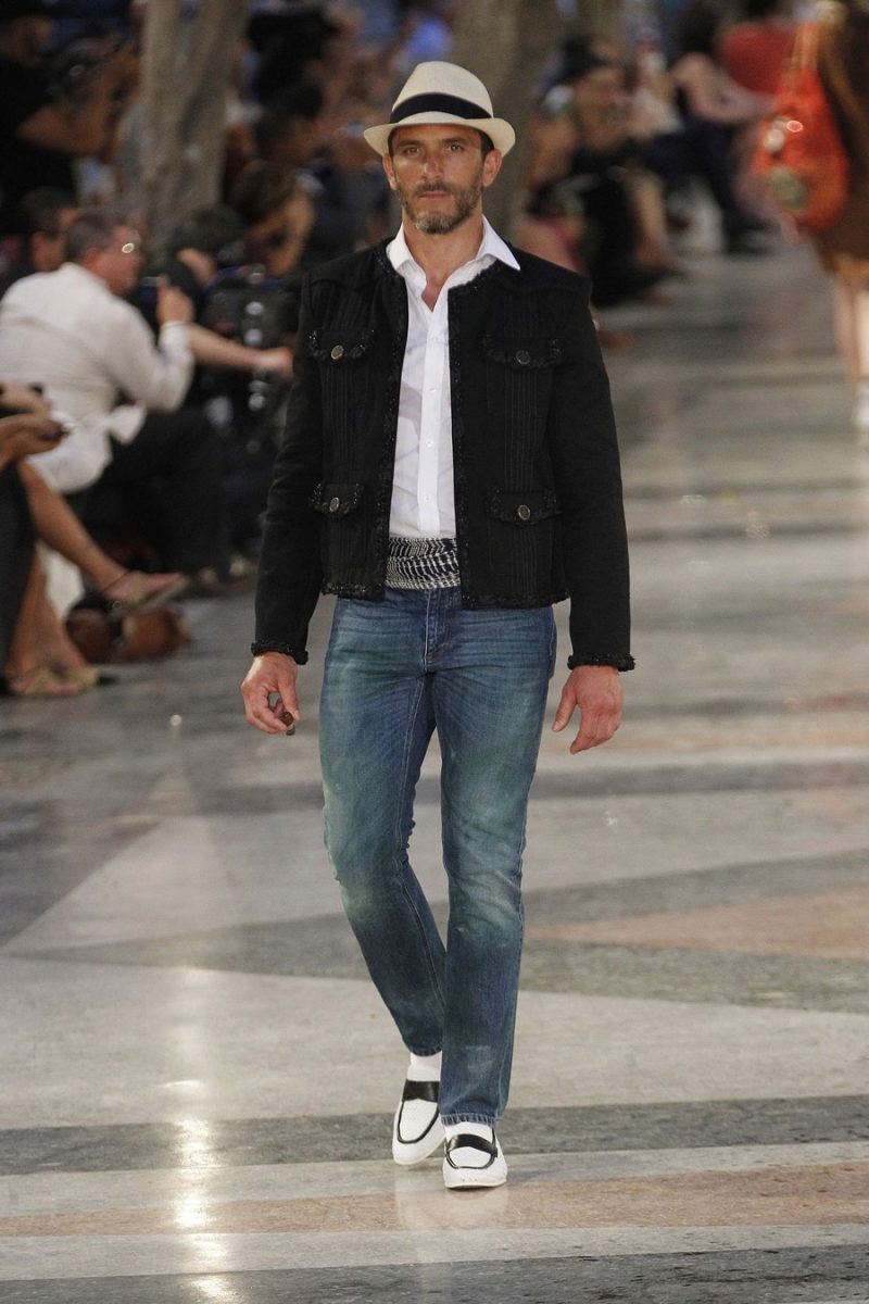 Chanel's iconic tweed jacket is repurposed for men for a casual companion to distressed denim jeans.