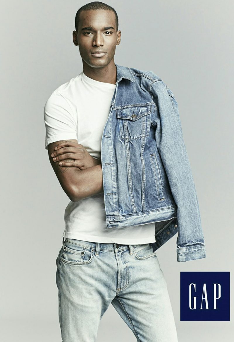 Corey Baptiste doubles down on denim, wearing a Gap denim jacket with distressed jeans