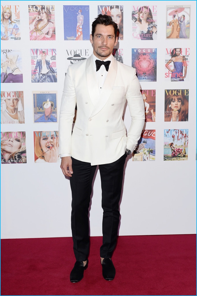 May 2016: David Gandy steps out for the Vogue 100 Festival Gala at Kensington Gardens. Charming in a dapper tuxedo that includes a white double-breasted dinner jacket, David wore Dolce & Gabbana.